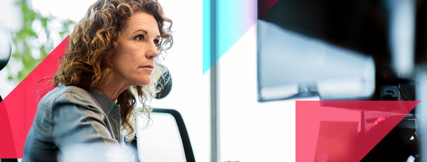 a woman is sitting in front of a computer monitor