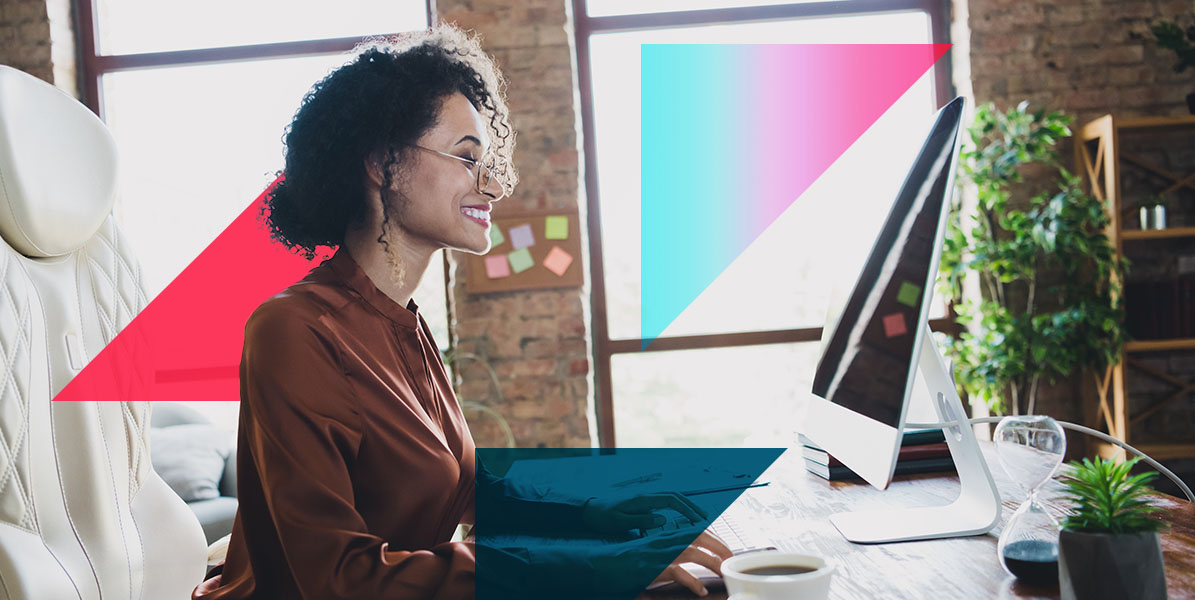 a woman is sitting at a desk in front of a computer