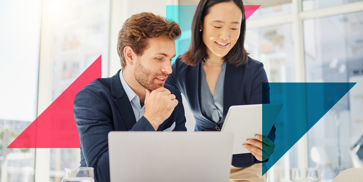 a man and a woman are looking at a laptop computer