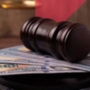 a judge 's gavel is sitting on top of a pile of money