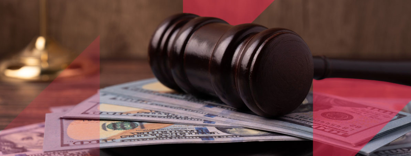 a judge 's gavel is sitting on top of a pile of money