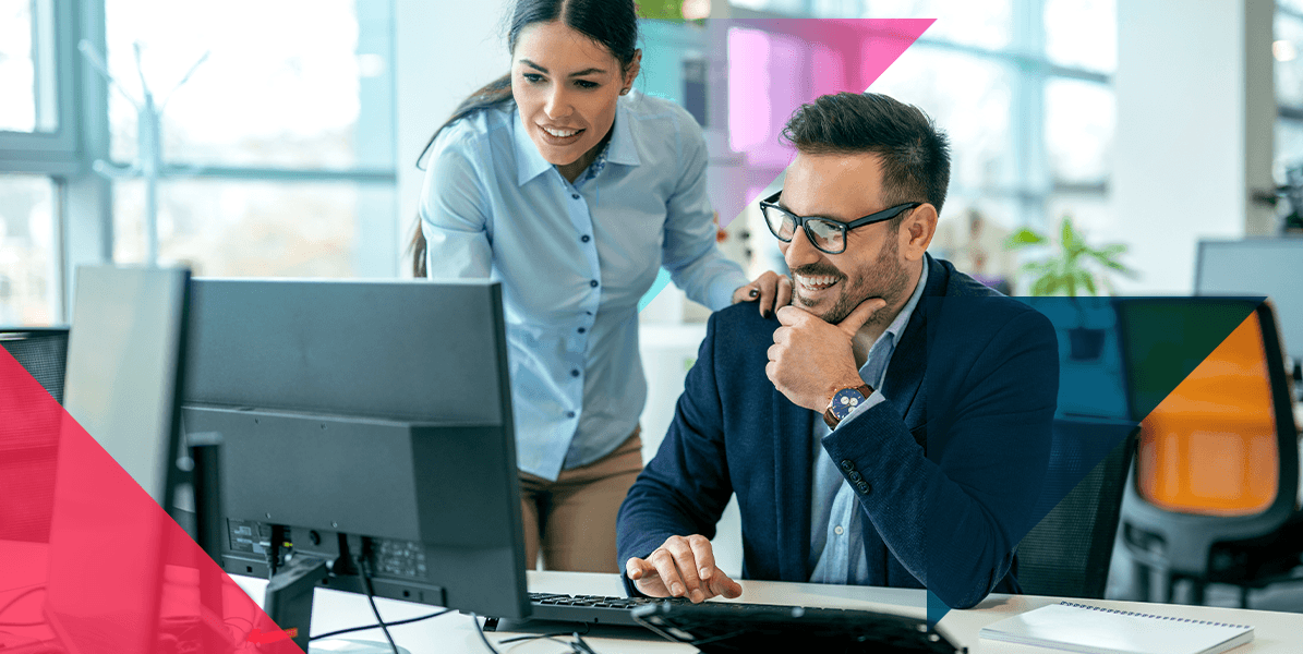 a man and a woman are looking at a computer screen