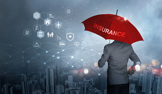 a man holding a red umbrella that says insurance